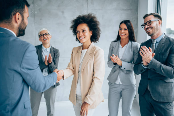 a group of people congratulating the applicant